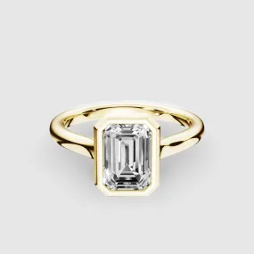 Slender Gold Shank Bezel Set Lab Grown Diamond Solitaire Ring with Cross Over Gallery-Emerald Cut